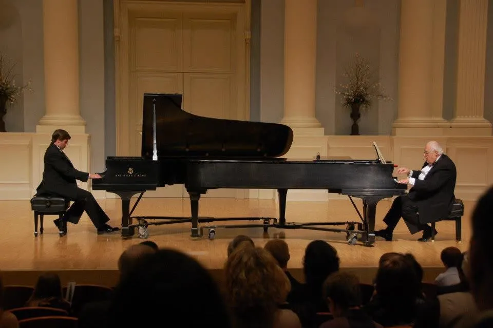 Dr. Jeffrey Tapley performing on stage in a two-piano concert